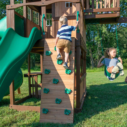Backyard Discovery Skyfort All Cedar Swing Set, Elevated Covered Wood Roof Clubhouse with Bay Windows, 2 Belt Swings, Web Swing, 10ft Wave Slide, 5 ft Tube Slide, Covered Picnic Table, 5 ft Rock Wall